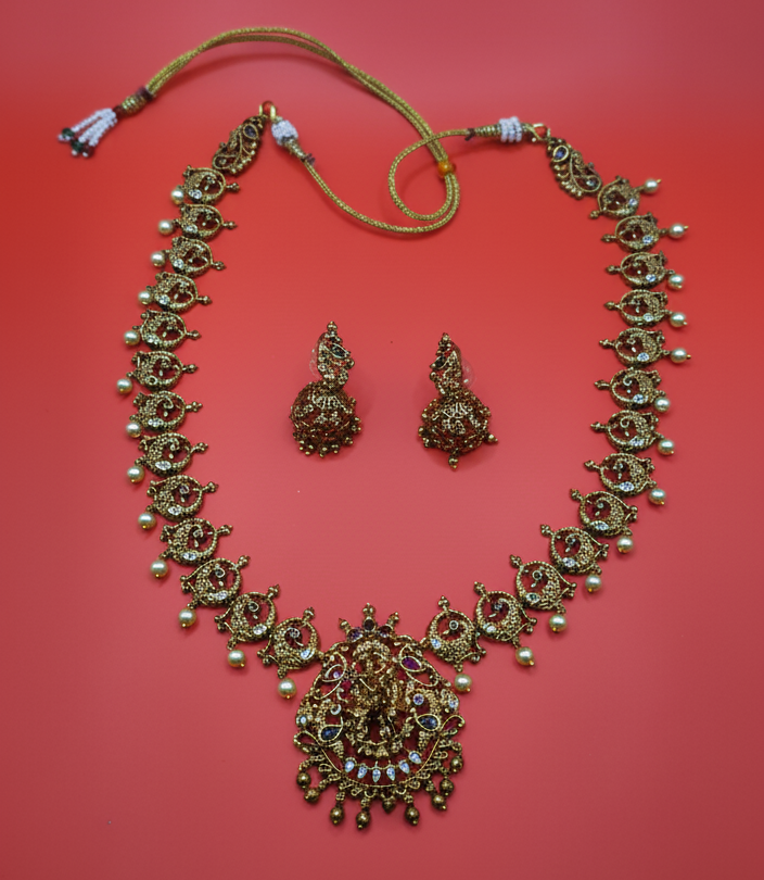 Gold necklace and earrings on a red background